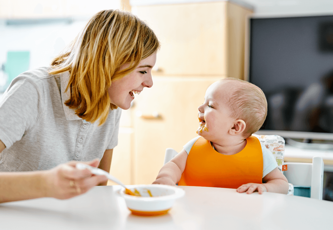 Parent feeding baby with a spoon
