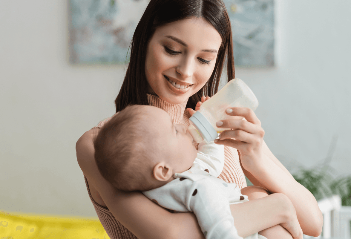 Parent bottle-feeding a baby